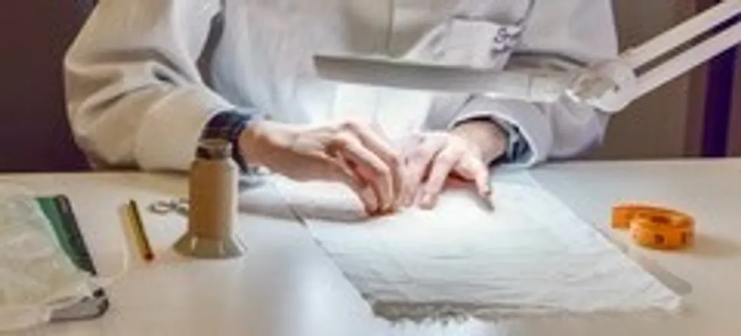 Hands examining textile fibers